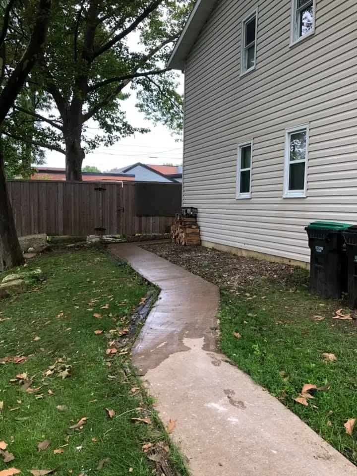 Exterior Home Cleanup After: A large collection of unwanted items and debris removed from alongside the home.